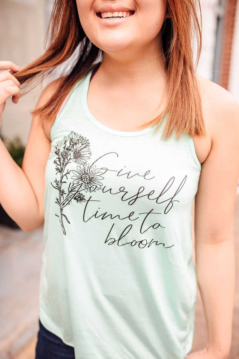 Give Yourself Time To Bloom © Ladies Flowy Racerback Tank (White)